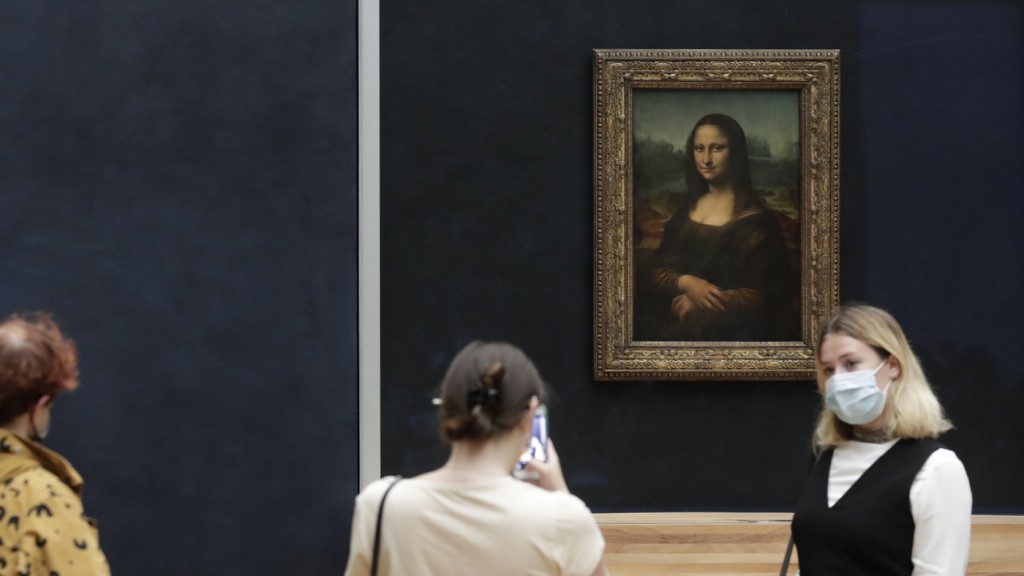 A man in a wig was detained after throwing a piece of cake at the Mona Lisa