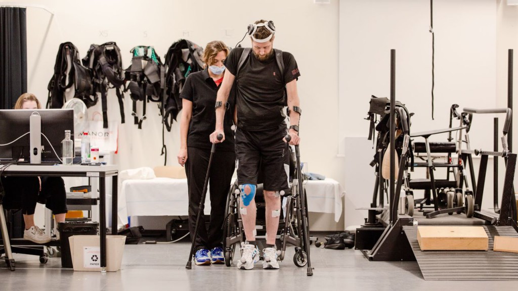 Man with paralysis walks naturally after brain, spine implants