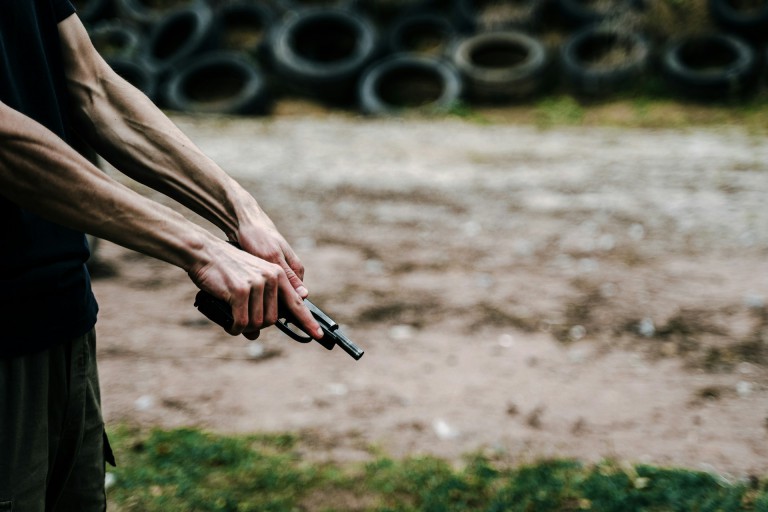 Man cocking a pistol.