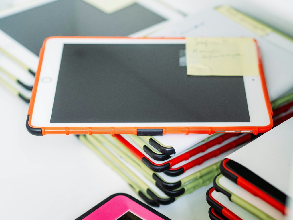 A stack of iPads used by students in school classrooms.