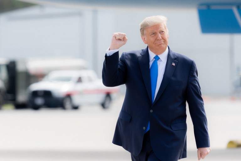 President Donald J. Trump gestures with a fist pump as he walks across the tarmac upon his arrival Thursday, Oct. 15, 2020, to Pitt-Greenville Airport in Greenville, S.C. (Official White House Photo by Shealah Craighead). Public domain.