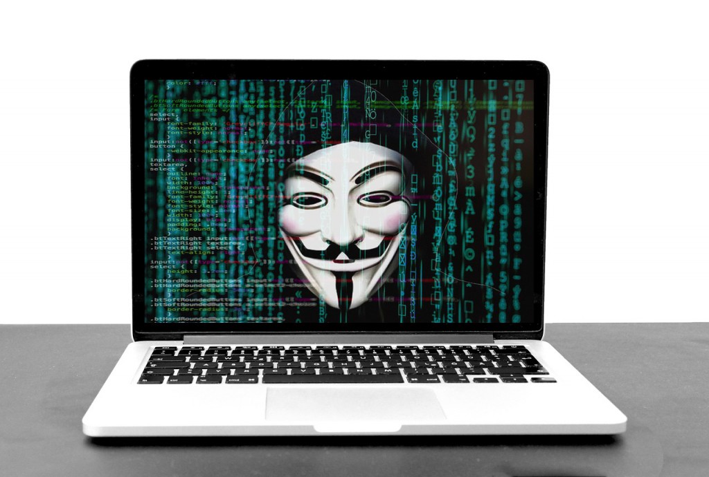 Laptop with code and a devious hacker on the screen. Image by vicky gharat from Pixabay. 