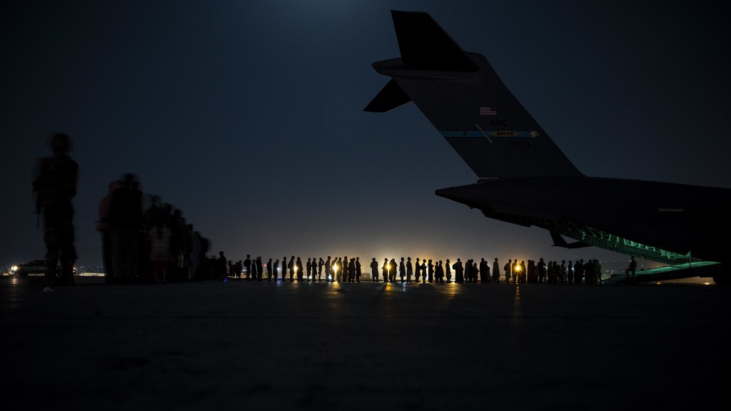 A U.S. Air Force aircrew prepare to load qualified evacuees aboard a U.S. Air Force C-17 Globemaster III aircraft in support of Afghanistan evacuation at Hamid Karzai International Airport, Afghanistan, Aug. 21, 2021. U.S. Air Force photo by Senior Airman Taylor Crul.