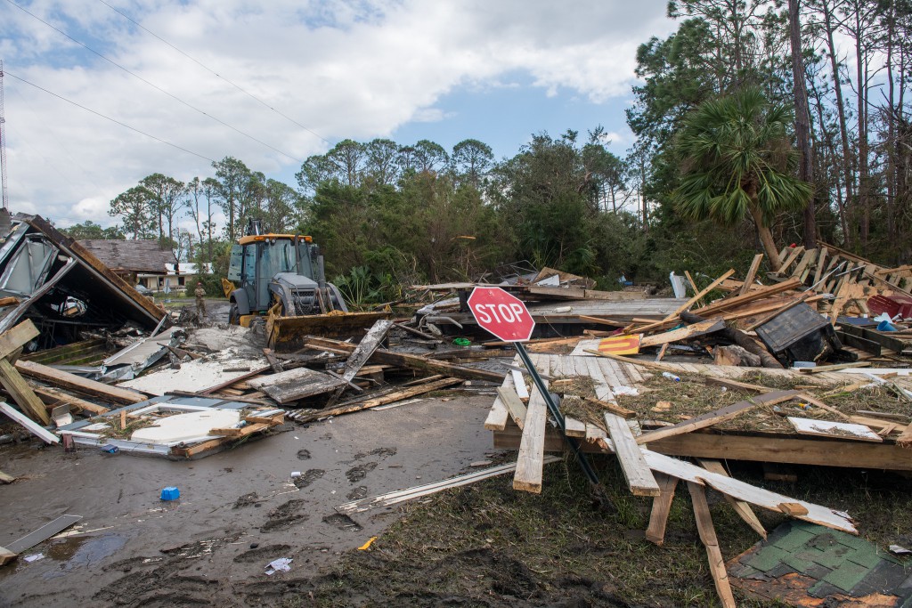 U.S. Airmen assigned to RED HORSE squadron, Florida Air National Guard, clear roads in Keaton Beach, Florida, after the landfall of Hurricane Helene, Sept. 27, 2024. (U.S. Air National Guard photo by Staff Sgt. Jacob Hancock)