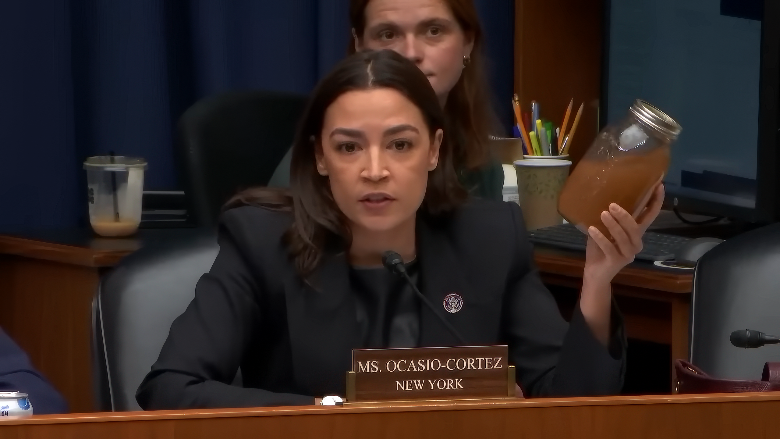 AOC brandishes jars of filthy water as she shames Trump official
